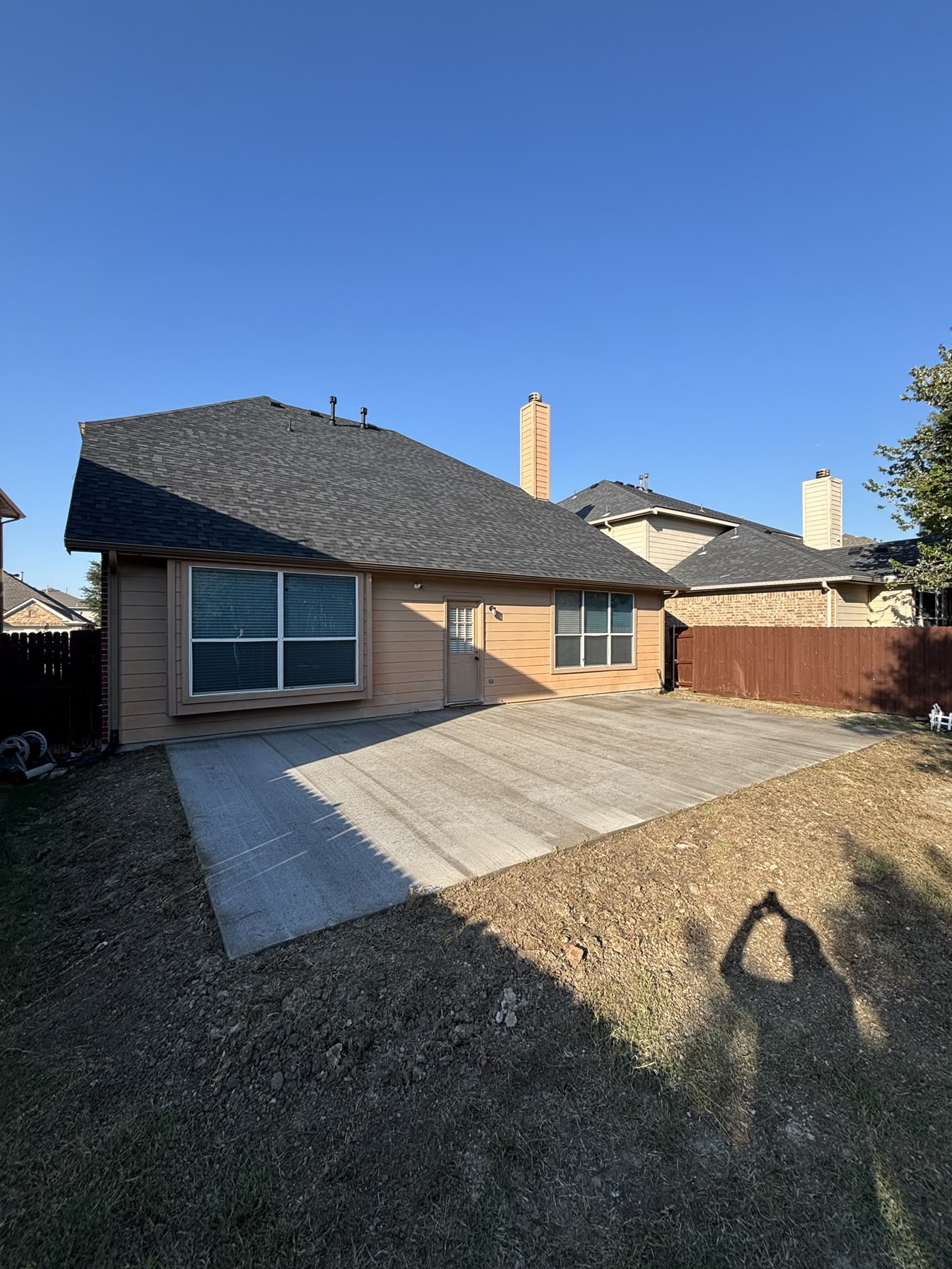 Finished broom-finish concrete backyard patio by Clean Slate Concrete, Fort Worth TX